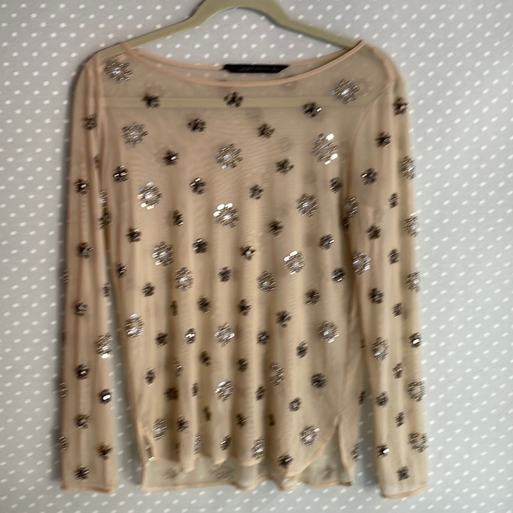 See through sequined blouse.